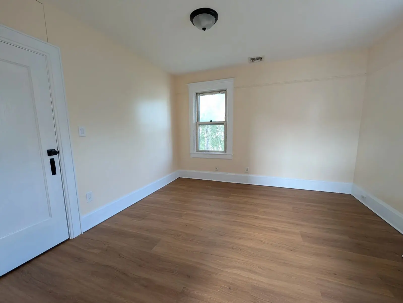 The third second-floor bedroom over warm floors with a window onto the yard