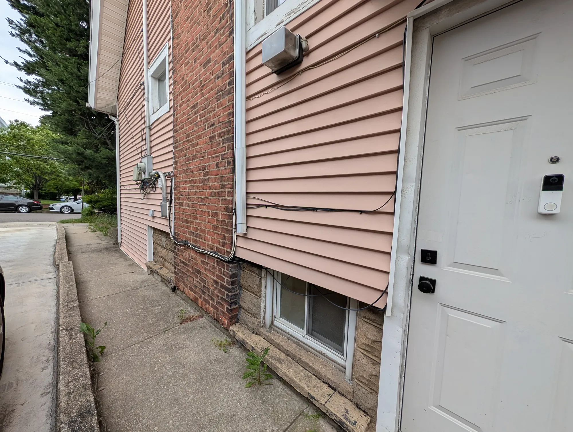 The west side of the house showing the roofline and siding