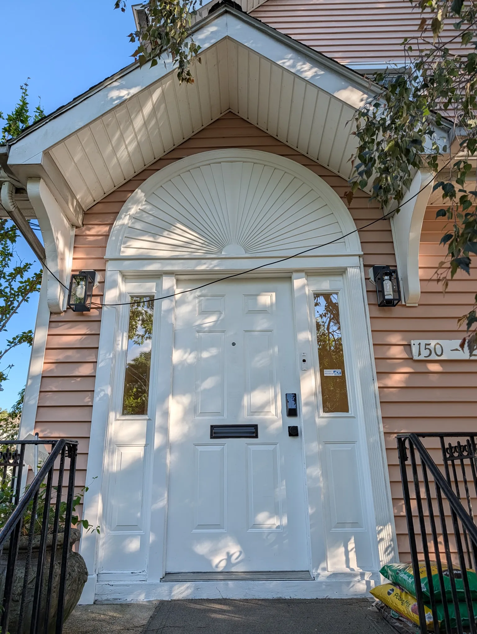 The white sunburst arch over the front door