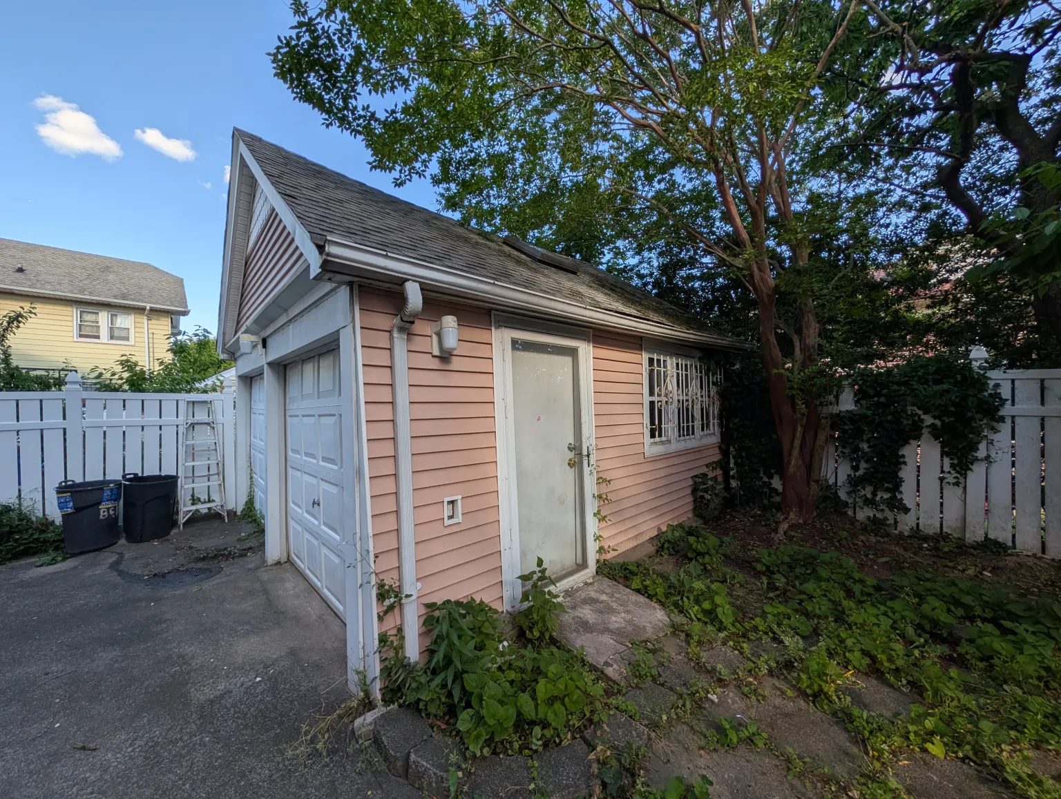 Side view of the garage with the peach siding