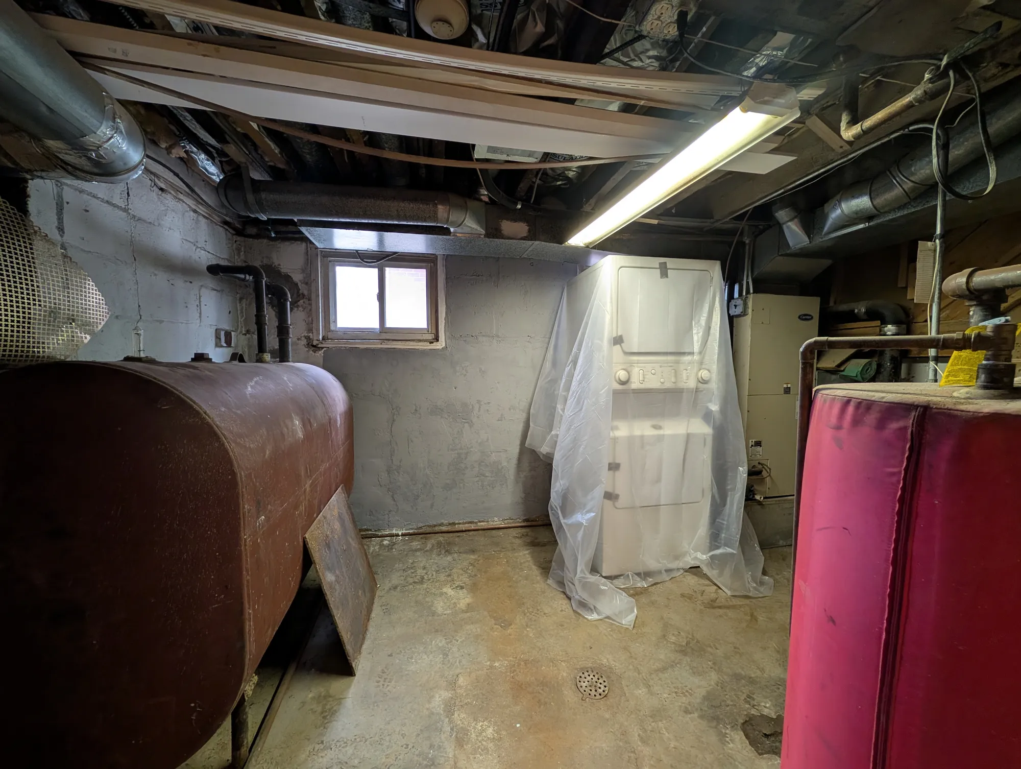 The mechanical room with the boiler, oil tank, and water heater