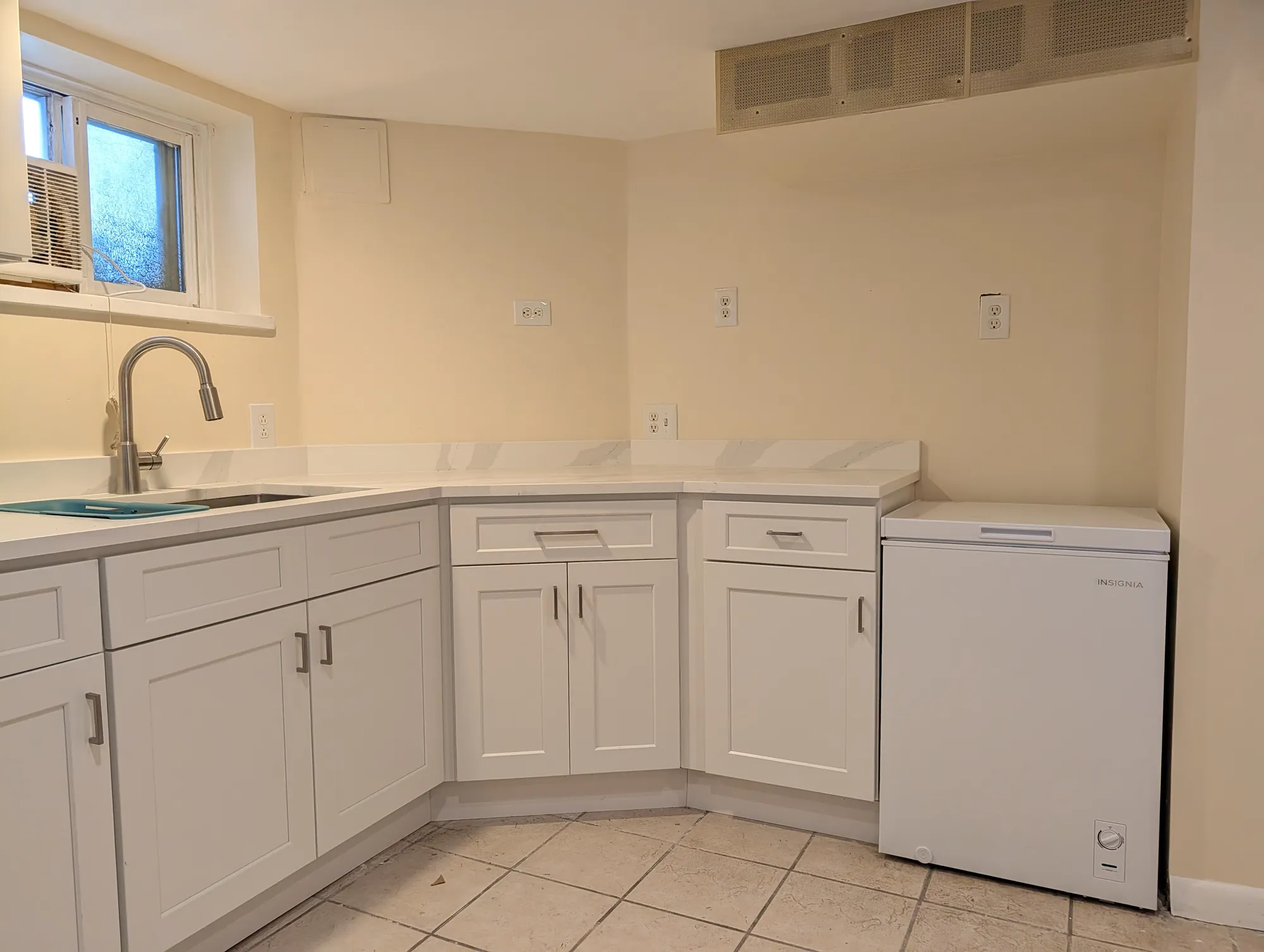 A chest freezer beside the laundry in the utility area