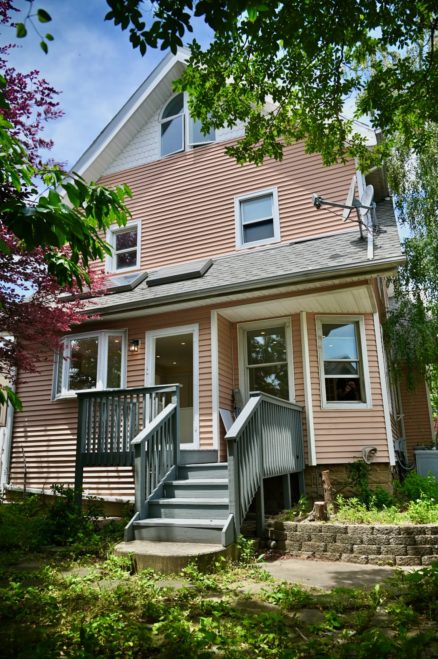 Rear elevation of the house showing the roofline and deck