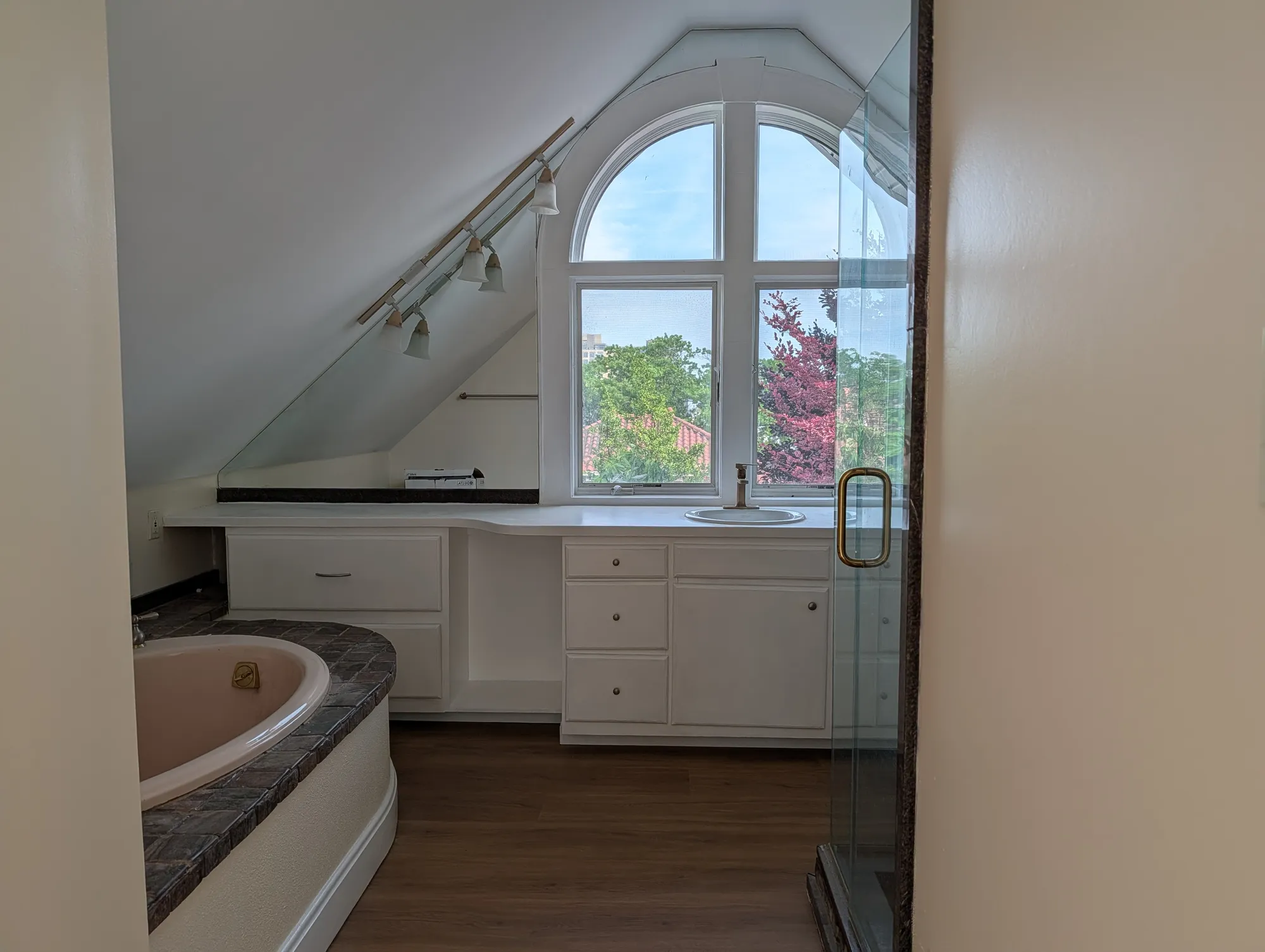 South-facing arched window in the suite under the vaulted ceiling