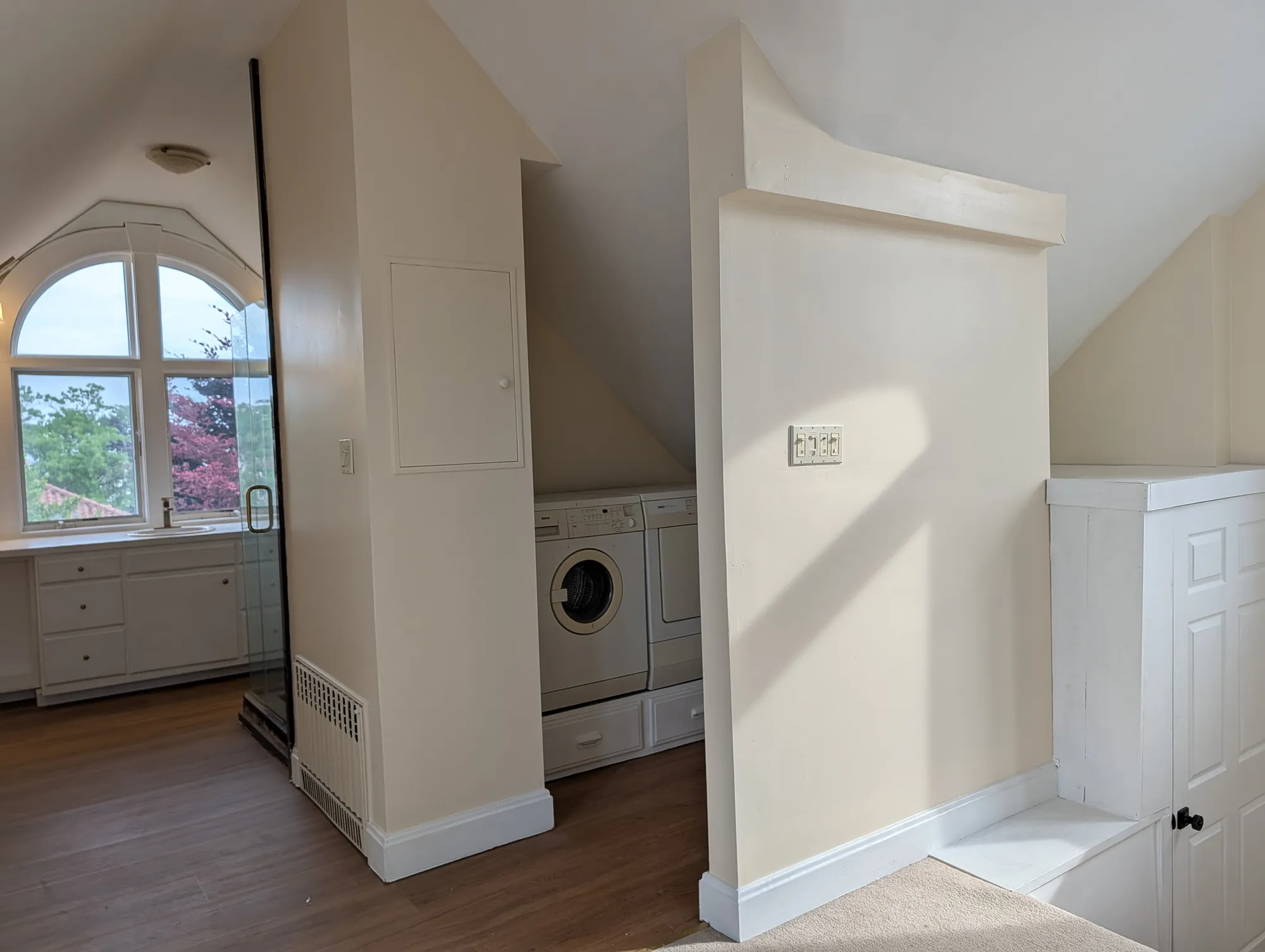 A washer and dryer tucked under the eave on the suite floor