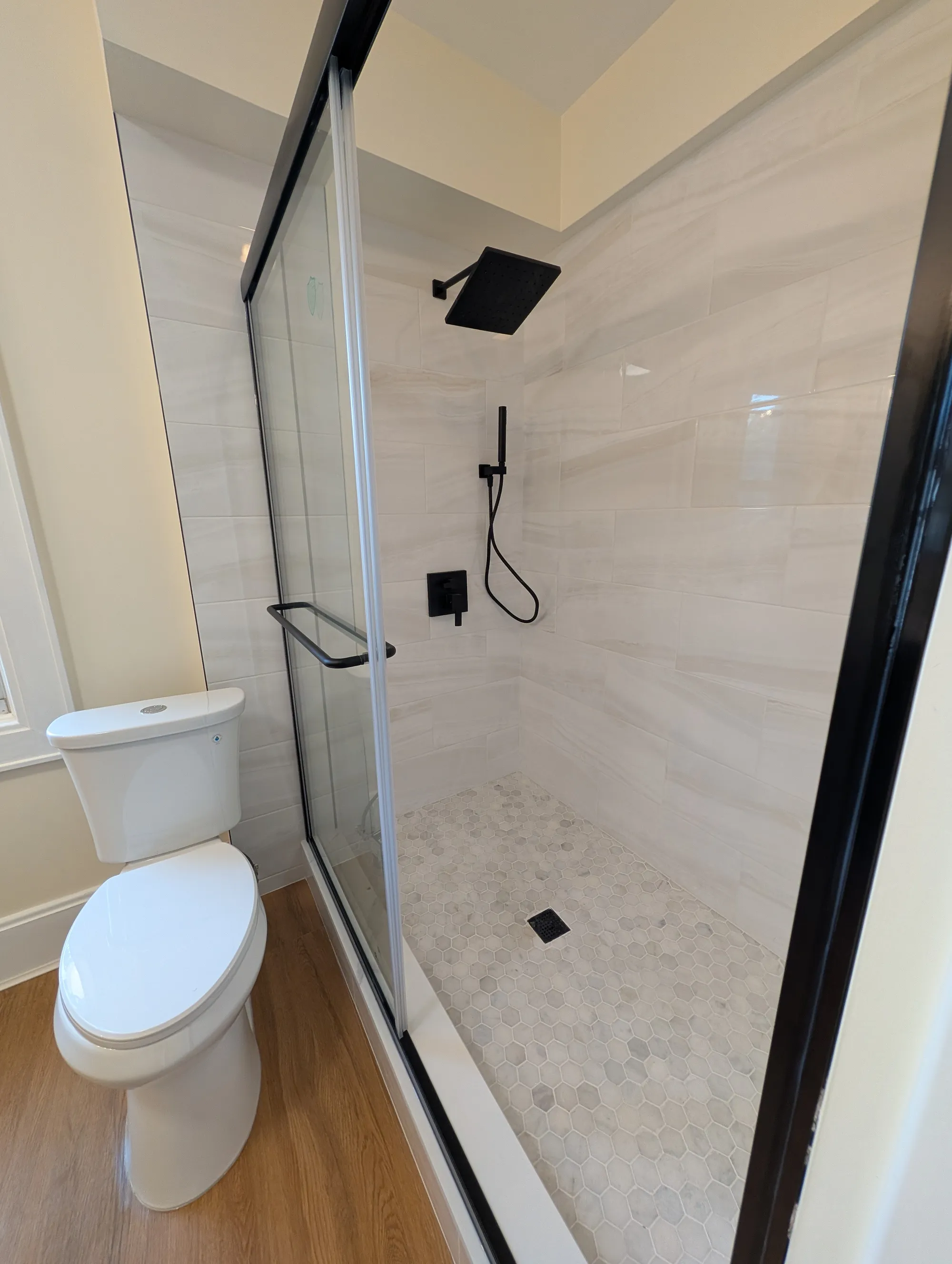 The frameless glass shower in the second-floor bath with a tiled surround